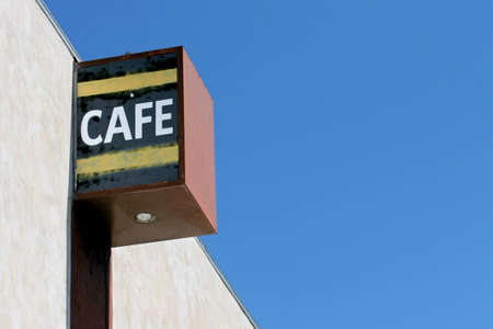 cafe sign on an old building, blue sky copyspaceの写真素材