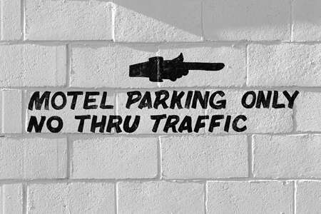 motel parking only sign on wallの写真素材