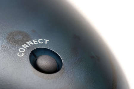 connect button of a wireless mouse receiver - macro isolated over whiteの写真素材