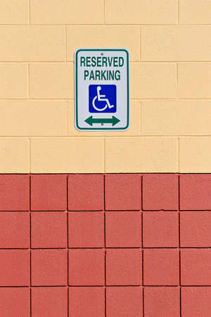 reserved handicap parking sign on a colorful wall