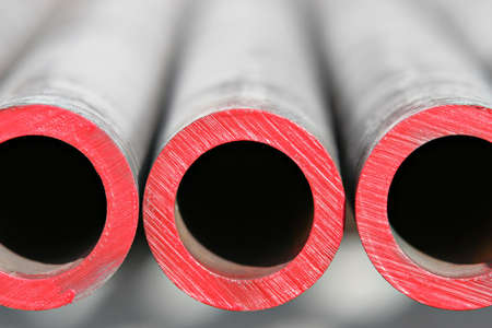 steel pipes - abstract close up of thick steel pipes for use in the oil industry. red paint indicates level of hardness.shallow depth of field.の写真素材