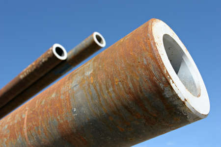 steel pipes, close up perspective against blue skyの写真素材