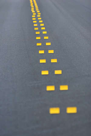 abstract background of fresh pavement with temporary markings. shallow depth of field with focus on pair of markers about 1/4 from top.の写真素材