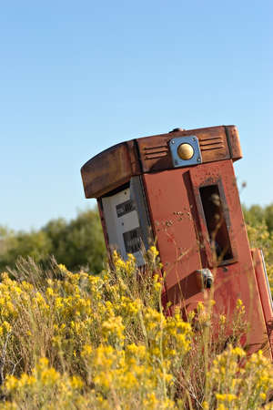 old abandoned gas pump in a contrasting settingの写真素材