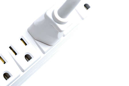 plug, plugged into a multiple outlet. highkey macro over white.の写真素材