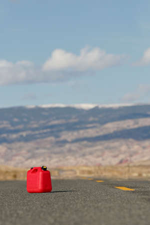 red spare / reserve gas tank on a remote highwayの写真素材