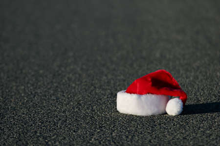 lost santa hat on the highway. horizontal version with shallow dof.の写真素材