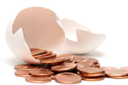 money egg - pennies pouring out of a broken egg, highkey over white with limited depth of fieldの写真素材