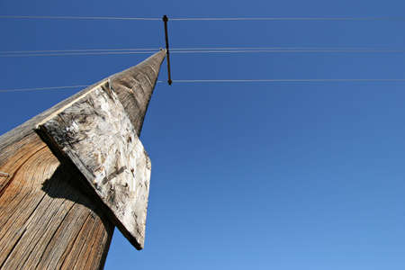 utility pole - old electricity pole with blank and worn wooden notice board.の写真素材