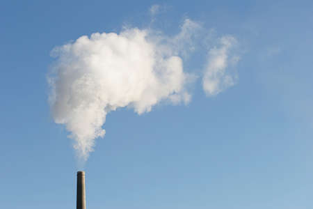 industry - industrial chimney with smoke, horizontal version with copyspaceの写真素材