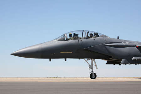 F-15 Strike Eagle taxiing to runway, closeup of cockpit with pilot and acknowledgement from the weapons systems officerの写真素材
