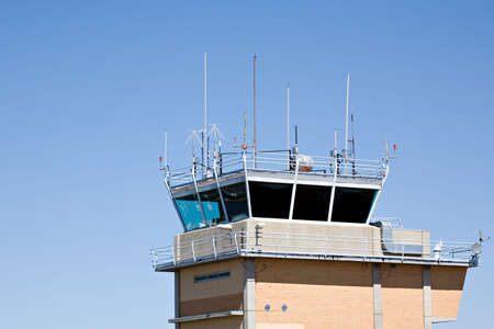 airport control tower against clear blue sky with copyspaceの写真素材