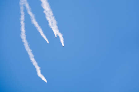 free fall - group of skydivers with smoke trails plummeting towards the groundの写真素材