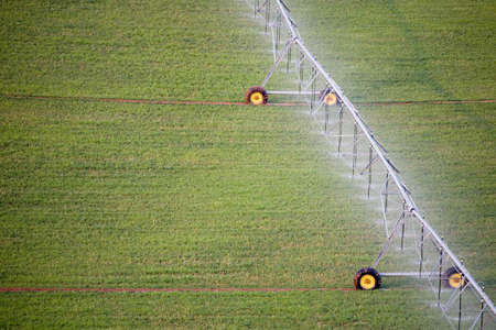 irrigation system in operation on field, shot from above with room for copyの写真素材