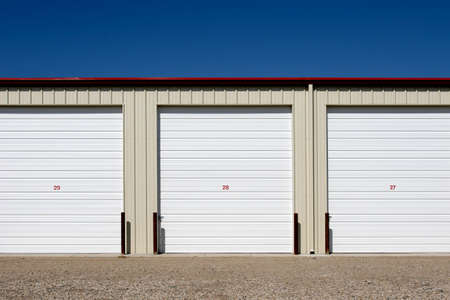 storage units, three numbered units against blue skyの写真素材