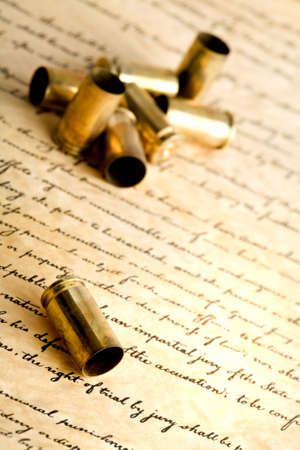 bullets - spent bullet cases, macro with focus on foremost shell, on bill of rightsの写真素材