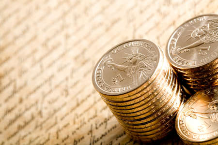 dollar coins - stacks of new US$1 coins on the declaration. limited dof, focus on lady liberty towards centerの写真素材