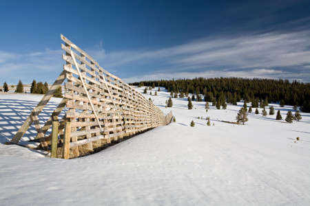 snow fence in the mountains of Wyoming, errected to protect the nearby mountain pass from snowdriftsの写真素材