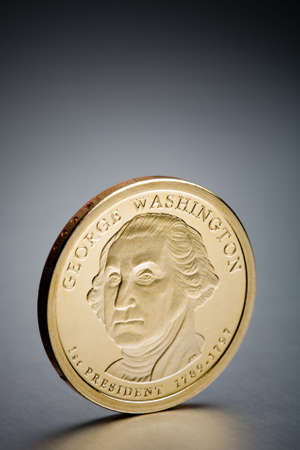 dollar coin - a new US$1 one dollar coin depicting George Washington, closeup shot on brushed metal backgroundの写真素材