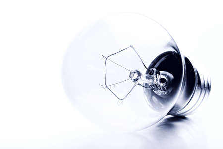 light bulb macro shot high-key over brushed metal, converted to monochrome
