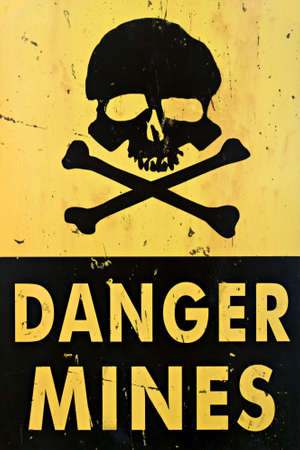 danger mines - old sign warning of land mines or minefield, closeupの写真素材