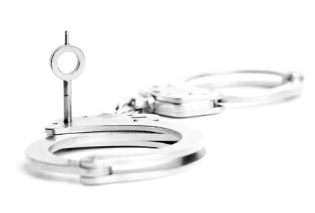 handcuffs key macro isolated on white. focus on key ring.の写真素材