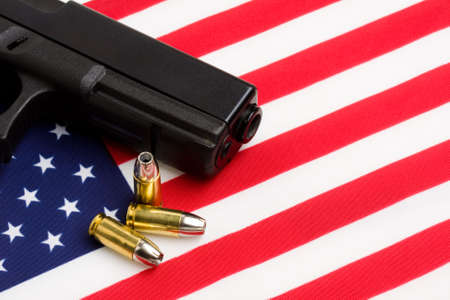 gun over american flag, modern 9mm handgun with bulletsの写真素材