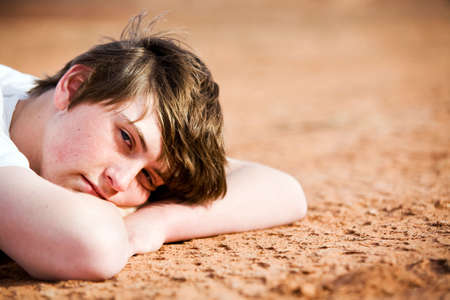 teenager male portrait laying on groundの写真素材
