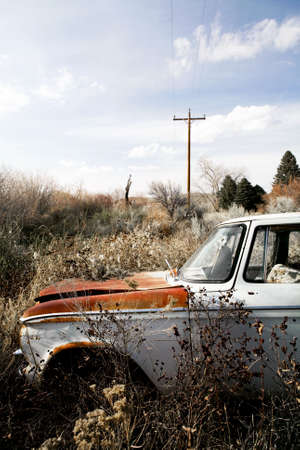 abandoned car with bullet hole through windshield, somewhere in the bushes of Wyomingの写真素材