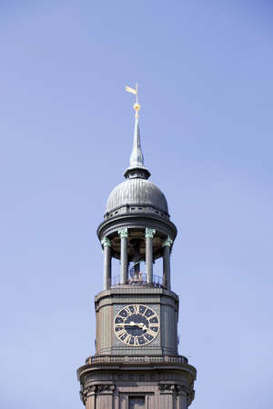 Michel (St. Michaelis) Church in Hamburg, Germany. Dedicated to the archangel Michael, built in 1786 after previous church destroyed by lightning strike. Closeup of clocktower agasint blue sky.の写真素材