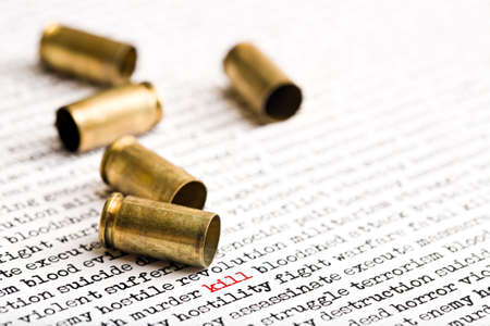 bullet shells over words depicting violence, death etcの写真素材