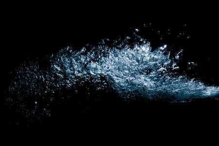 blast of air bubbles in water - high pressure closeup on black