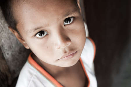 Portrait of a Filipino boy living in poverty - natural light - Manila, Philippines.の写真素材