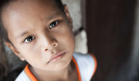 Portrait of a Filipino boy living in poverty - natural light - Manila, Philippinesの写真素材