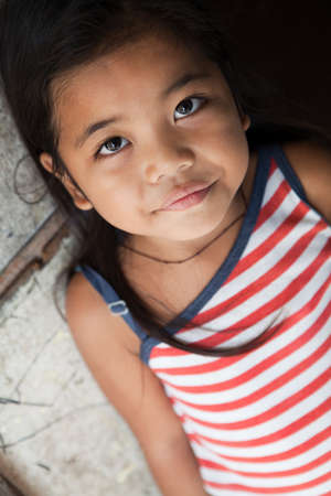 Asian girl portrait - Filipina against wall in natural lightの写真素材