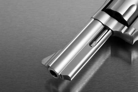 gun on metal - modern revolver handgun on stainless steel surfaceの写真素材