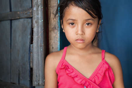 Portrait of a young girl from poverty-stricken area in Manila, the Philippines.の写真素材