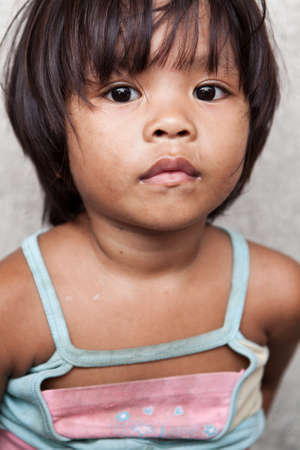 Adorable young girl living in poverty in Manila, the Philippines.の写真素材