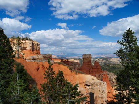 View of the red and white hoodoos  with blue skies and white clouds at Bryce Canyon National Park in Utah.の写真素材