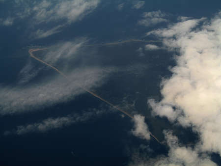 an island visible through the clouds