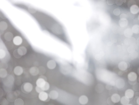 Blurred abstract gray and white background with highlights and bokehの写真素材