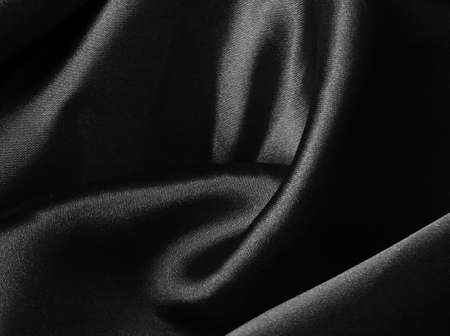 Black crumpled fabric background. Liquid wavy clothの写真素材