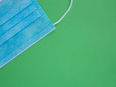 Medical sterile protective blue mask closeup on a green backgroundの写真素材