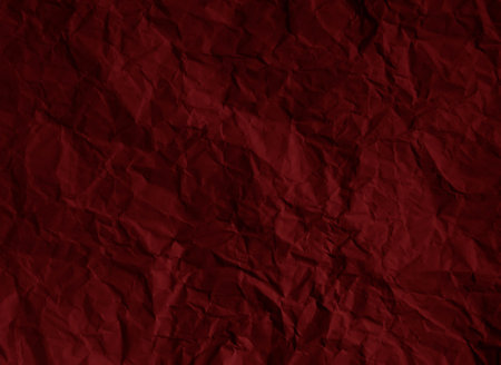Crumpled dark red paper texture backgroundの写真素材