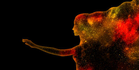 Red and yellow shining star universe in the shape of a woman's profile silhouette with outstretched hand on a black backgroundの写真素材