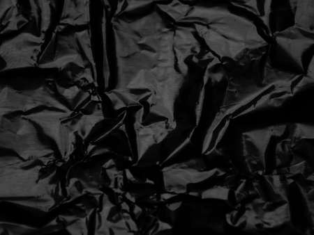 Wrinkled black foil texture backgroundの写真素材