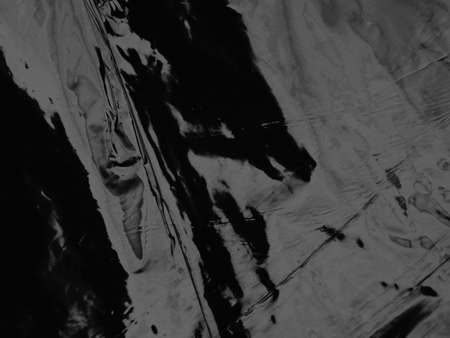 Wrinkled black foil texture backgroundの写真素材
