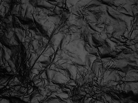 Wrinkled black foil texture backgroundの写真素材
