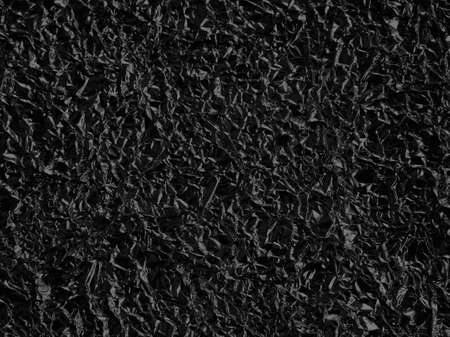Black crumpled foil texture backgroundの写真素材