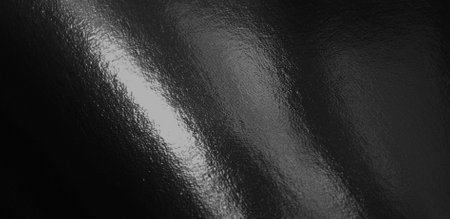 Black foil gradient texture background with uneven surfaceの写真素材